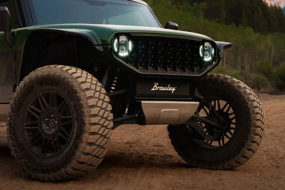 Brawley front skid plate, lower control arms, and coil-over shocks between deep-tread tires