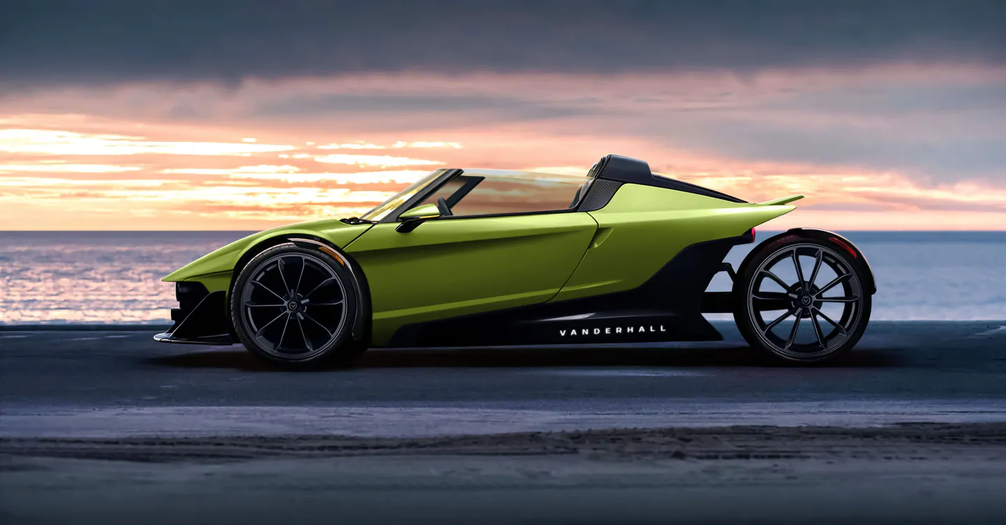 Green Vanderhall Indio concept side profile at the ocean at sunset